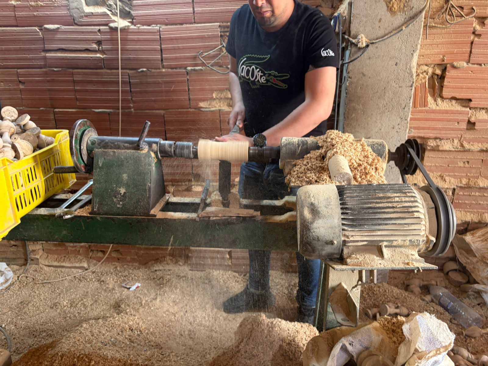 Artisan cutting olive wood on a band saw
