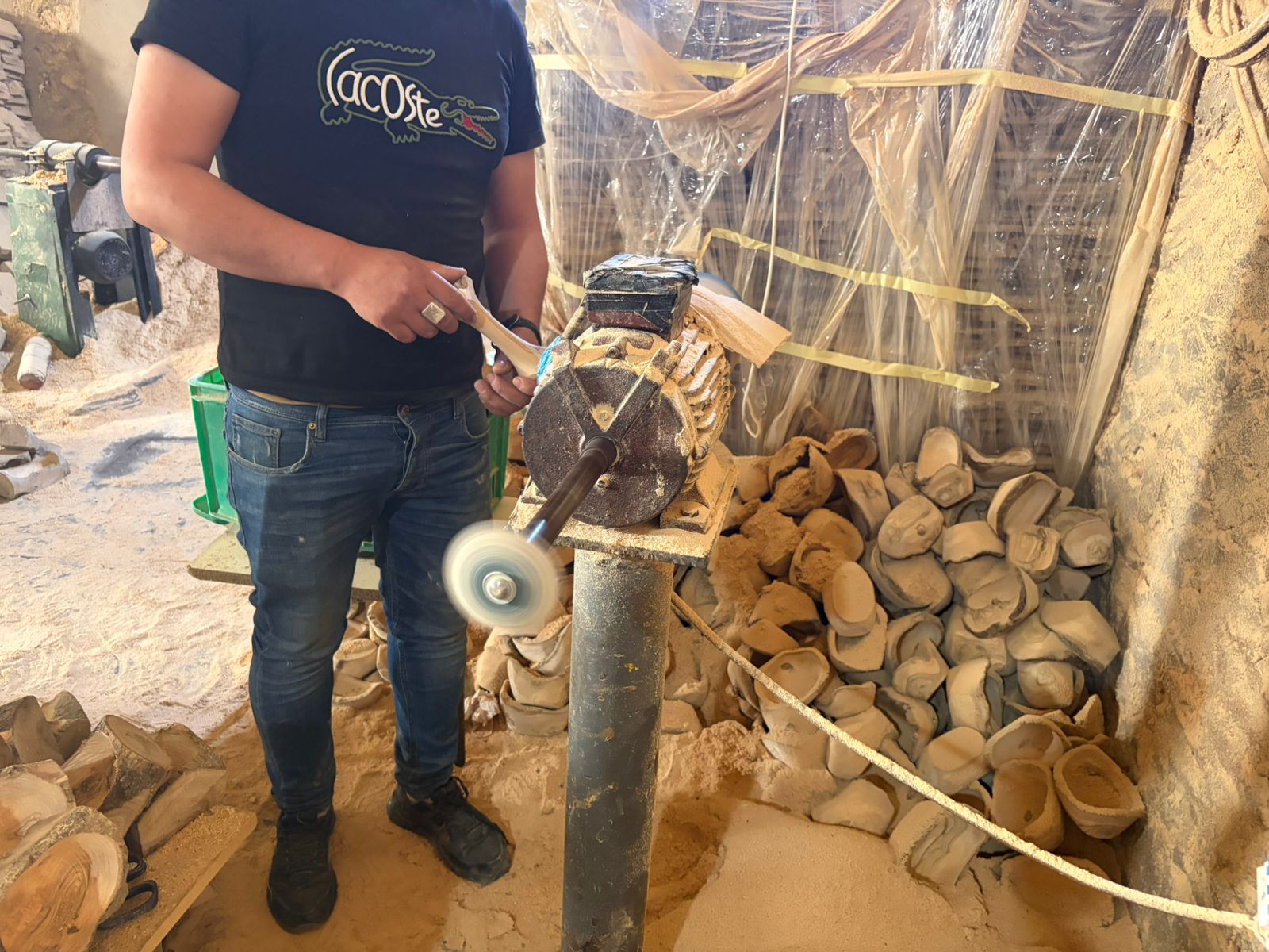 Artisan buffing a finished olive wood chew to a shine